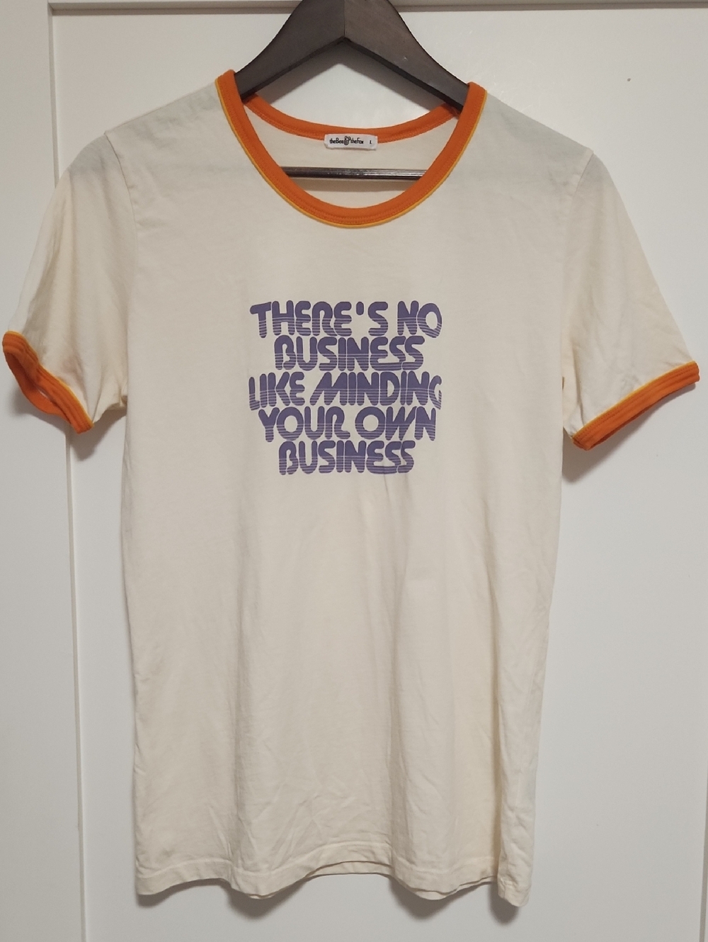 Cream Ringer Tee with Orange Trim and Purple Text